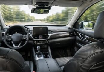 The inside of a vehicle with a view as if you are sitting in the rear left seat